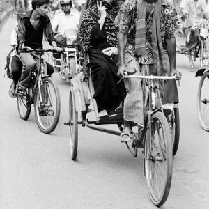 Cycle rickshaw running with passenger