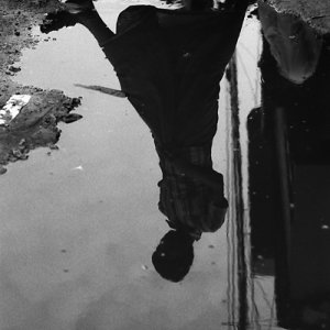 Figure reflected in puddle