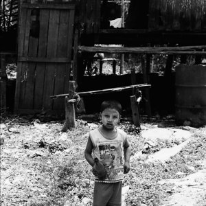 Boy standing in front of house
