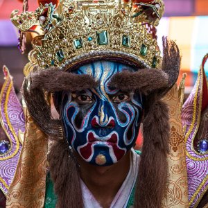 Blue face of an actor wearing a costume