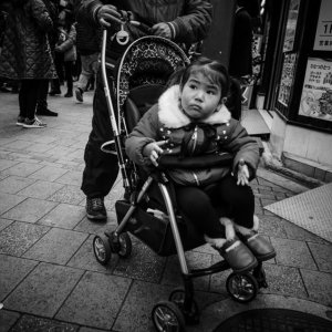 Little girl on baby buggy