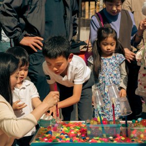 Parent and children playing at stall