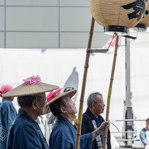 Man holding long pole with lantern