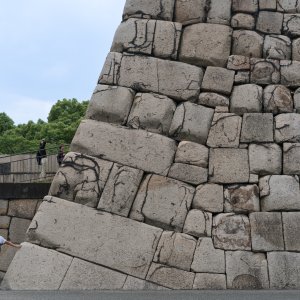 Man putting hand to stone wall