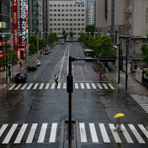 Yellow umbrella on pedestrian crossing