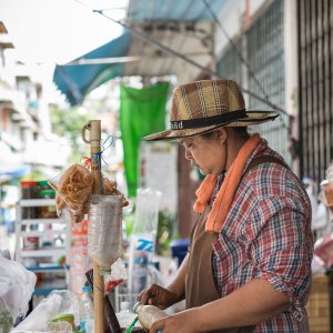 Hatted woman in food stall