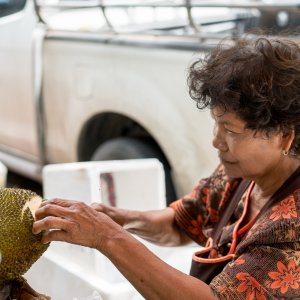 Woman cutting jackfruit