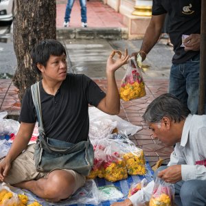 Man selling floral offerings