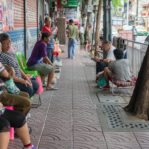 People relaxing on sidewalk