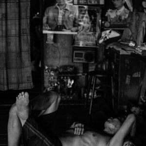 Man sleeping on wooden floor