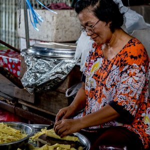 Woman cutting bamboo sprouts