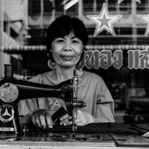 Woman working with old sewing machine