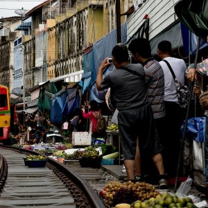 Train running in Mae Klong Railway Market