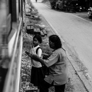 Girl and older woman getting on train