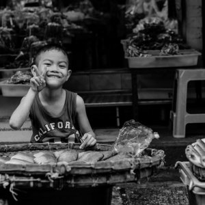 Boy selling dried fishes
