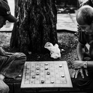 Men playing game on sidewalk