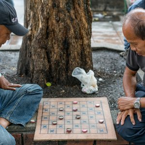Men playing game on sidewalk
