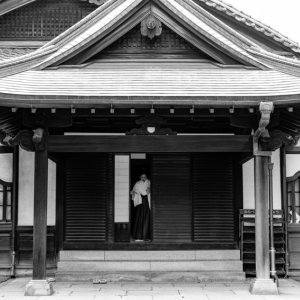 Shinto priestess getting into a building