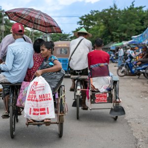 Pedicabs running street with passengers