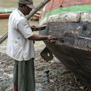 Man repairing fishing boat