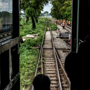 Railway track stretching straight on the other side of open door