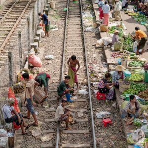 Three men hanging out on the railway track
