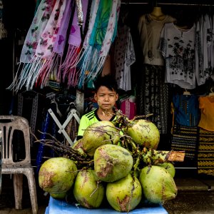 Boy selling coconuts