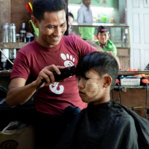 Barber cutting happily
