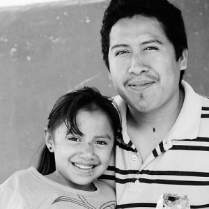 Father and girl smiling together