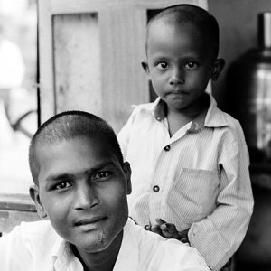 Shaven^headed boy and man