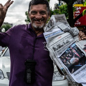 Man selling newspapers on the street