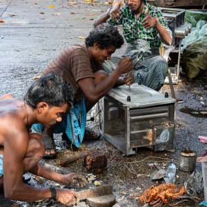 Men repairing electronic goods