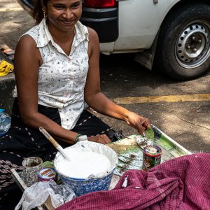 Woman selling Kun by roadside