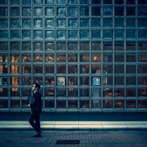 Businessman walking in front of glassed wall