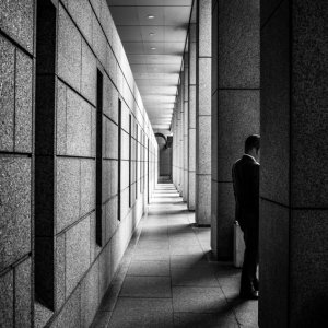 Man standing between pillars