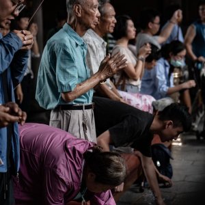 Many locals praying seriously in Lungshan Temple