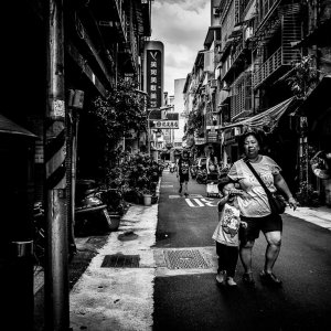 Stout mother and her little son walking lane