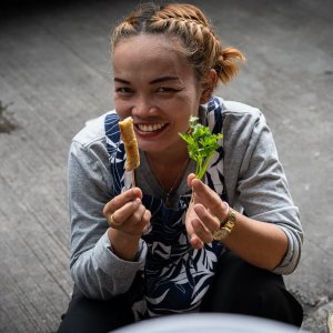 Woman with skewer and coriander