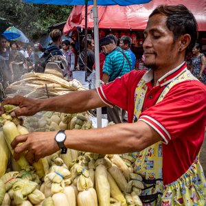 Man selling steamed corns in Khlong Toei Market