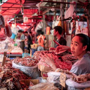 Woman selling dried fishes in Khlong Toei Market