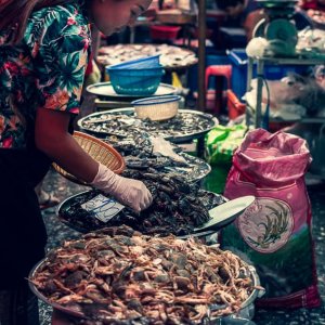 Woman selling crabs and shrimps in Khlong Toei Market