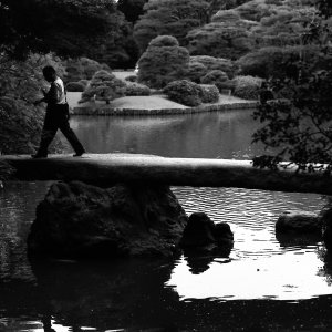 Man walking on stone bridge