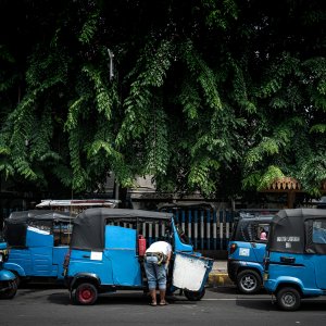Blue three-wheeled taxi called Bajaj