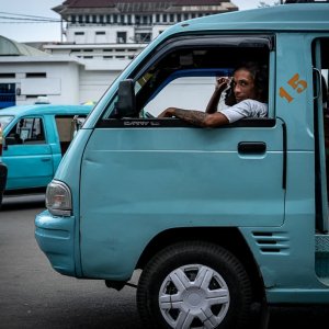 Man on Angkot directing a keen look