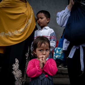 Little girl putting her hands to her mouth in front of Jakarta Kota Station
