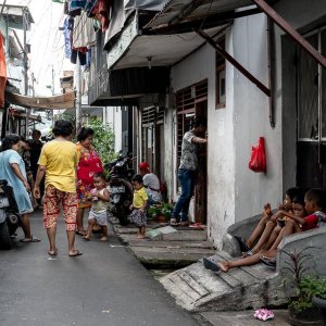 People hanging out in the narrow lane in the residential area