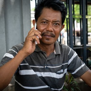 Bad-tempered man making a phone call on the sidewalk