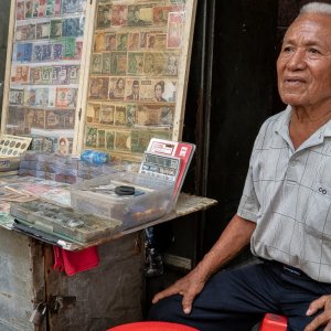 Old man selling old coins and bills in Pasar Baru