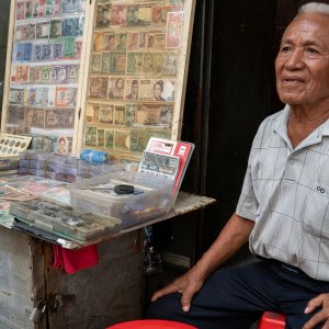 Old man selling old coins and bills in Pasar Baru