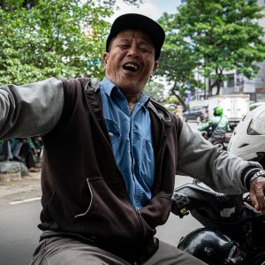 Motorbike taxi driver waiting for customers at an intersection